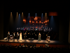 Soloists, choir and orchestra on stage in La Traviata, presented by Israel Chamber Opera.