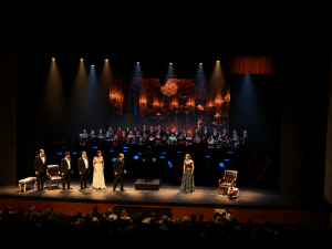 Soloists, choir and orchestra on stage in La Traviata, presented by Israel Chamber Opera.